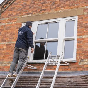 worker installing window