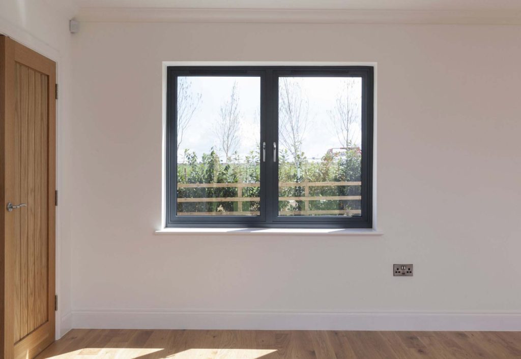 Choosing the Right Casement Windows for Your Milton Keynes Home 2 Black casement double-glazed window in a modern home, offering insulation and a sleek design.