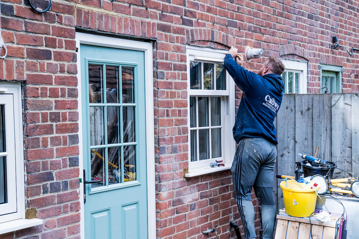 crown worker installing new sliding sash window