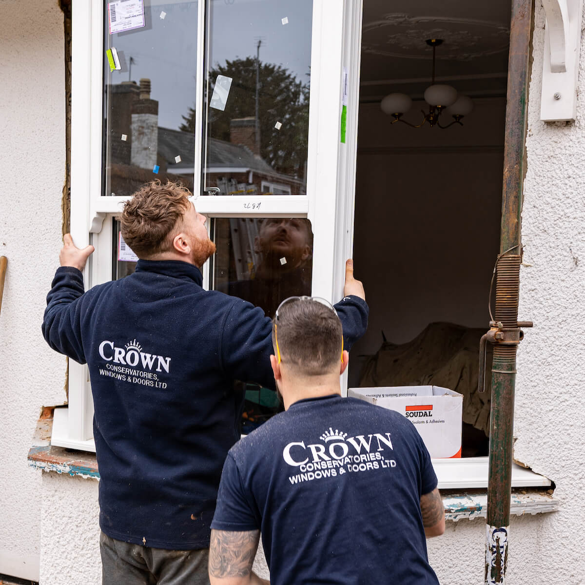 double glazing workers installing bay window