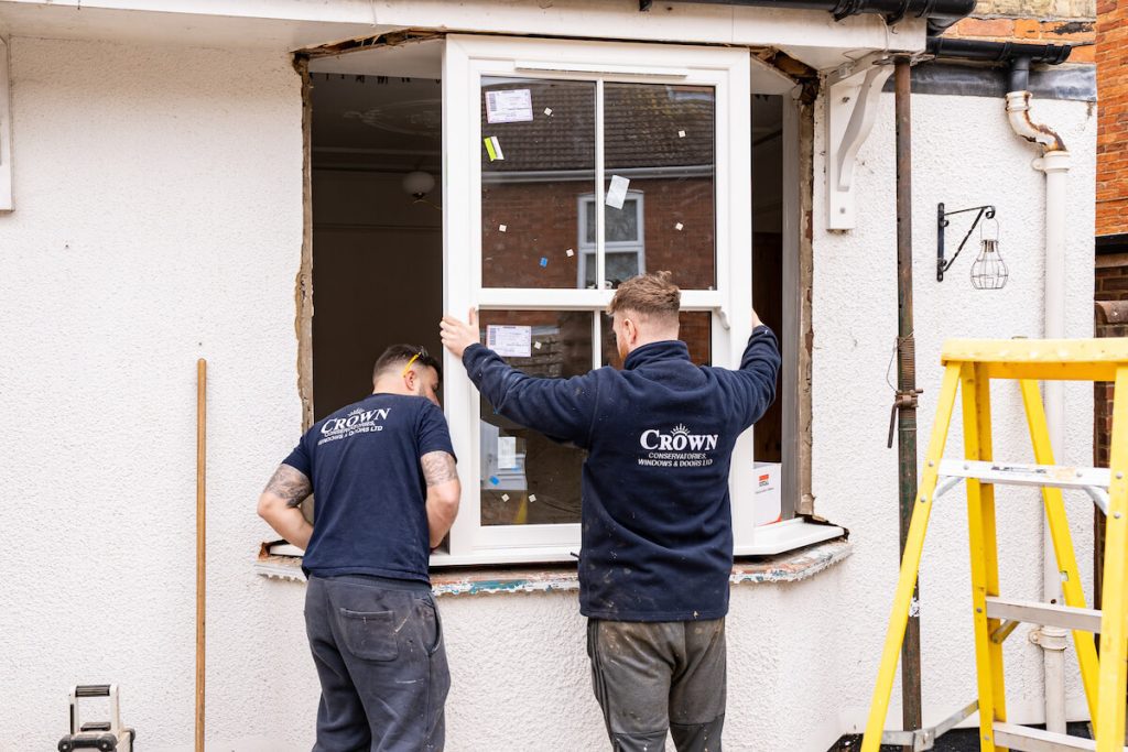 workers installing bay window