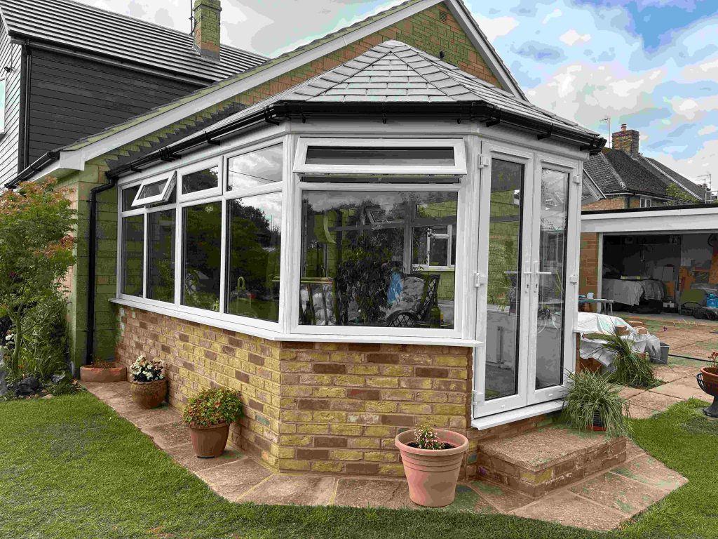 The Crown team installing a Victorian conservatory in Northamptonshire. The conservatory is in the Victorian style, and has been completed with a Guardian warm roof for added insulation. There is a large garden, with the roof promising year-round comfort.